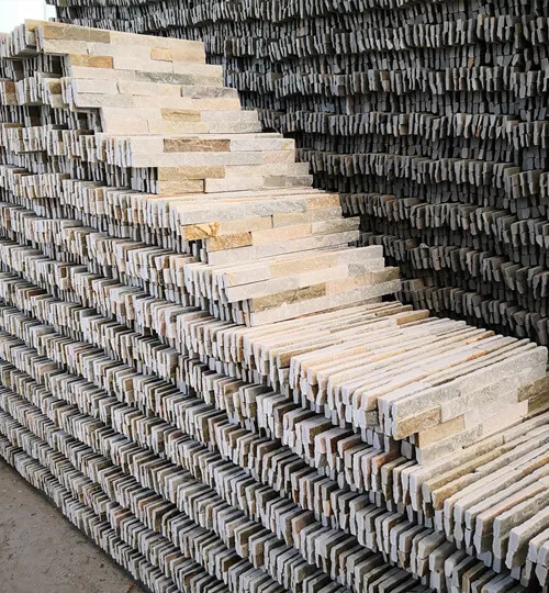 A spacious warehouse displaying neatly arranged stacked stone panels.